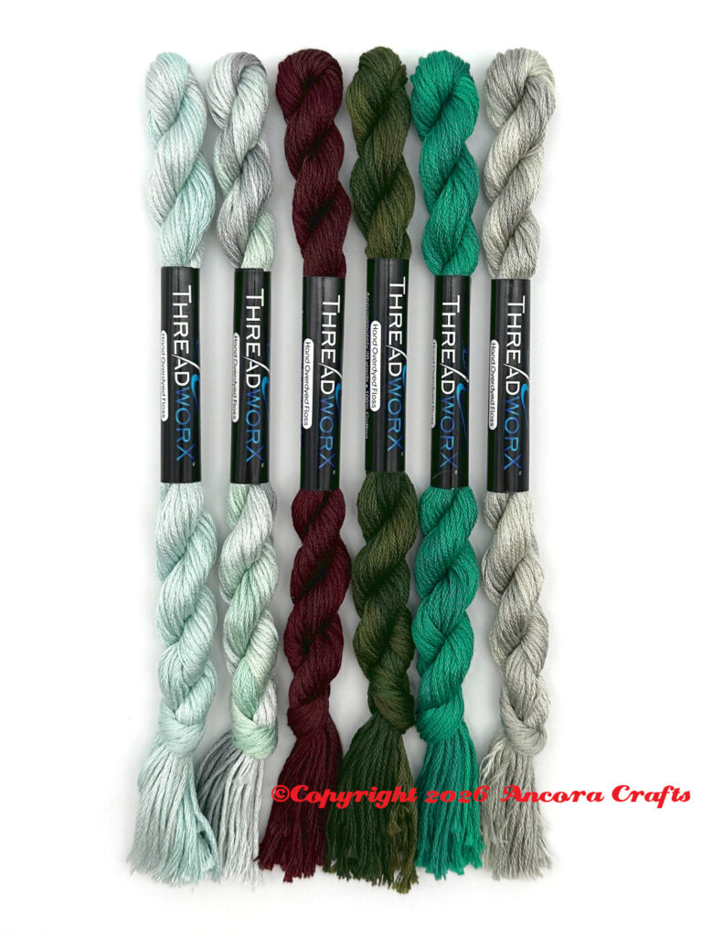 These are ThreadworX new floss colors for 2026. There's a light arctic blue, an aqua green gray, a dark brown, a forest green, a bright teal, and a green gray.